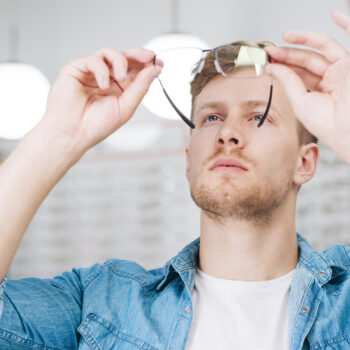 man-looking-new-glasses-optometrist